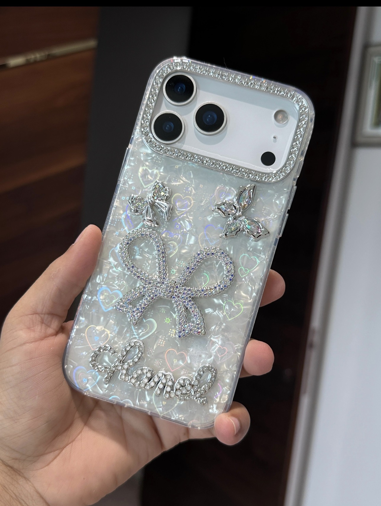 A glam pearl-white phone case with sparkling rhinestone details,